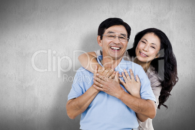 Composite image of smiling couple holding each other