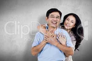 Composite image of smiling couple holding each other