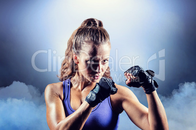 Composite image of portrait of female confident boxer with fight