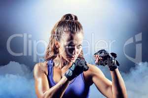 Composite image of portrait of female confident boxer with fight