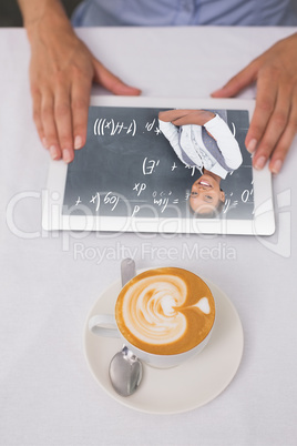 Composite image of close-up of digital tablet and coffee on tabl