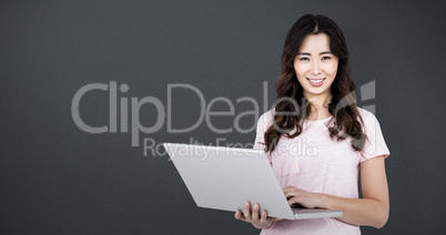 Composite image of portrait of happy woman holding laptop