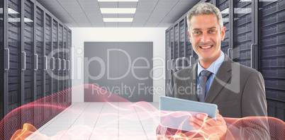 Composite image of happy businessman using tablet pc