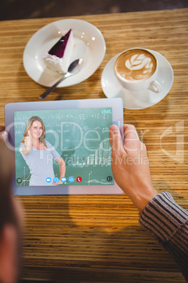 Composite image of smiling teacher gesturing thumbs up in front