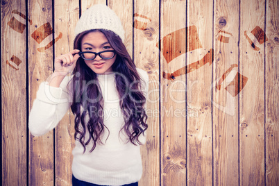 Composite image of smiling asian woman holding eyeglasses