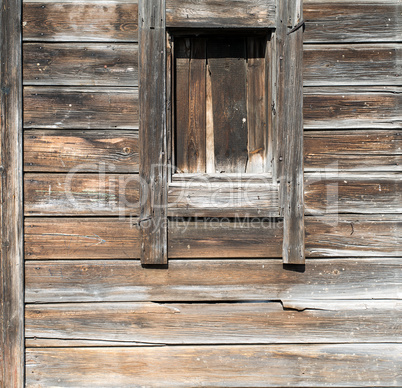 Background texture wall of wooden logs. Weathered pine planks