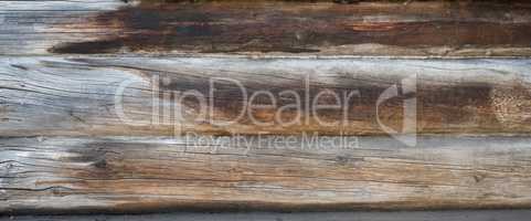 Background texture wall of wooden logs. Weathered pine planks