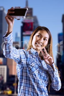 Composite image of smiling asian woman taking picture with camer