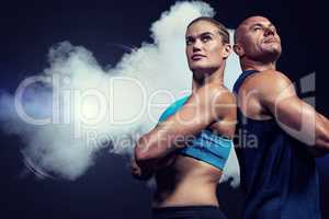 Composite image of low angle view of muscular man and woman