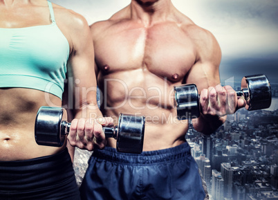 Composite image of midsection of woman and man exercising with d