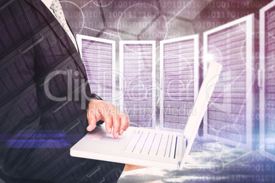 Composite image of businessman holding laptop