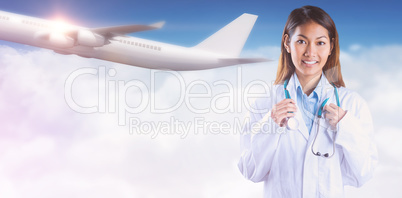 Composite image of asian doctor holding stethoscope