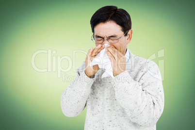 Smiling man using a tissue