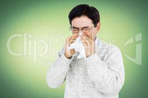 Smiling man using a tissue