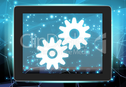 Tablet with gears on abstract background communications network