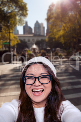 Composite image of asian woman smiling at the camera