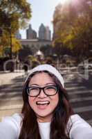 Composite image of asian woman smiling at the camera