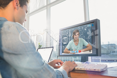 Composite image of businessman using computer at desk in creativ