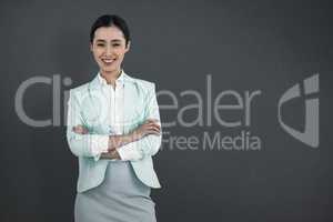 Composite image of elegant businesswoman with crossed arms