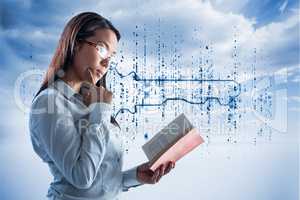 Composite image of concentrated businesswoman reading book