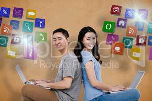 Composite image of portrait of young happy couple using laptop w