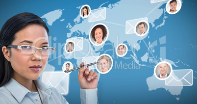 Composite image of attractive businesswoman holding pen