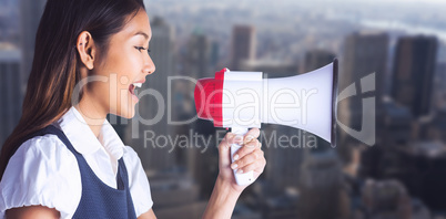 Composite image of businesswoman shooting through a megaphone