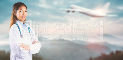 Composite image of asian doctor with arms crossed looking at the