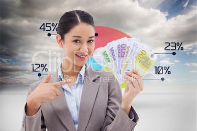 Composite image of smiling businesswoman holding bank notes