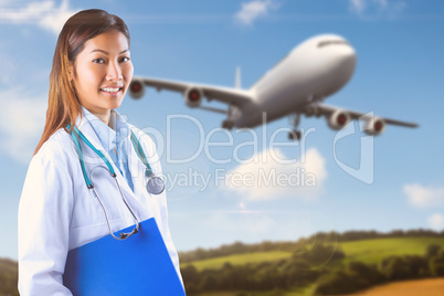 Composite image of asian doctor holding blue binder