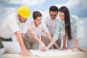 Composite image of architecture team working together at desk