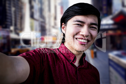 Composite image of hipster man taking a selfie