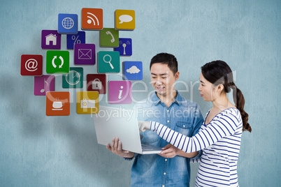 Composite image of couple using laptop