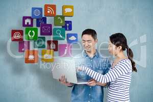 Composite image of couple using laptop