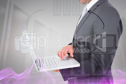 Composite image of businessman holding laptop