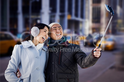 Composite image of couples taking funny pictures using smartphon