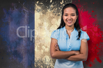 Composite image of smiling businesswoman with arms crossed