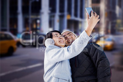 Composite image of cute couple taking selfie