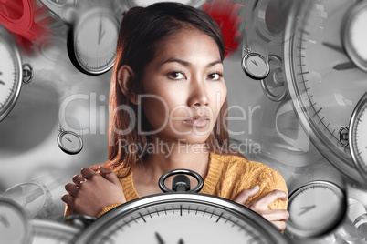 Composite image of serious asian woman with hands on shoulders