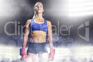 Composite image of female athlete standing with gloves
