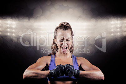 Composite image of aggressive female boxer flexing muscles