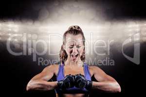 Composite image of aggressive female boxer flexing muscles
