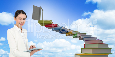Composite image of smiling businesswoman using her tablet