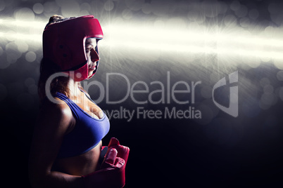 Composite image of side view of female boxer with headgear and g
