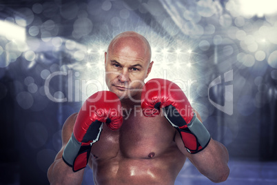 Composite image of portrait of bald boxer in red gloves