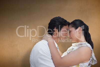 Composite image of happy couple hugging each other