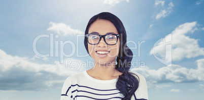 Composite image of smiling asian woman with arms crossed looking Composite image of smiling asian woman with arms crossed looking