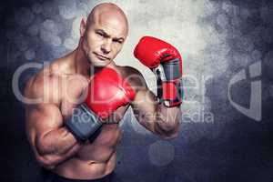 Composite image of portrait of boxer with red gloves