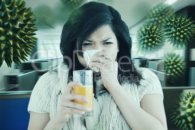 Composite image of woman holding a glass of orange juice while s