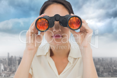 Composite image of closeup of a businesswoman looking through bi